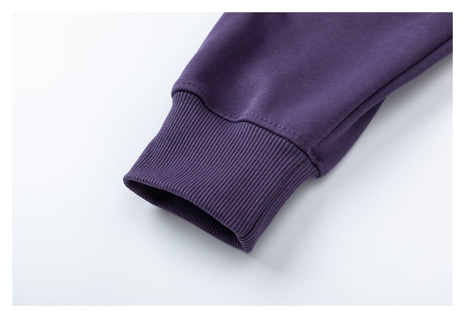Close-up of a purple sweatshirt sleeve ending in a ribbed cuff.