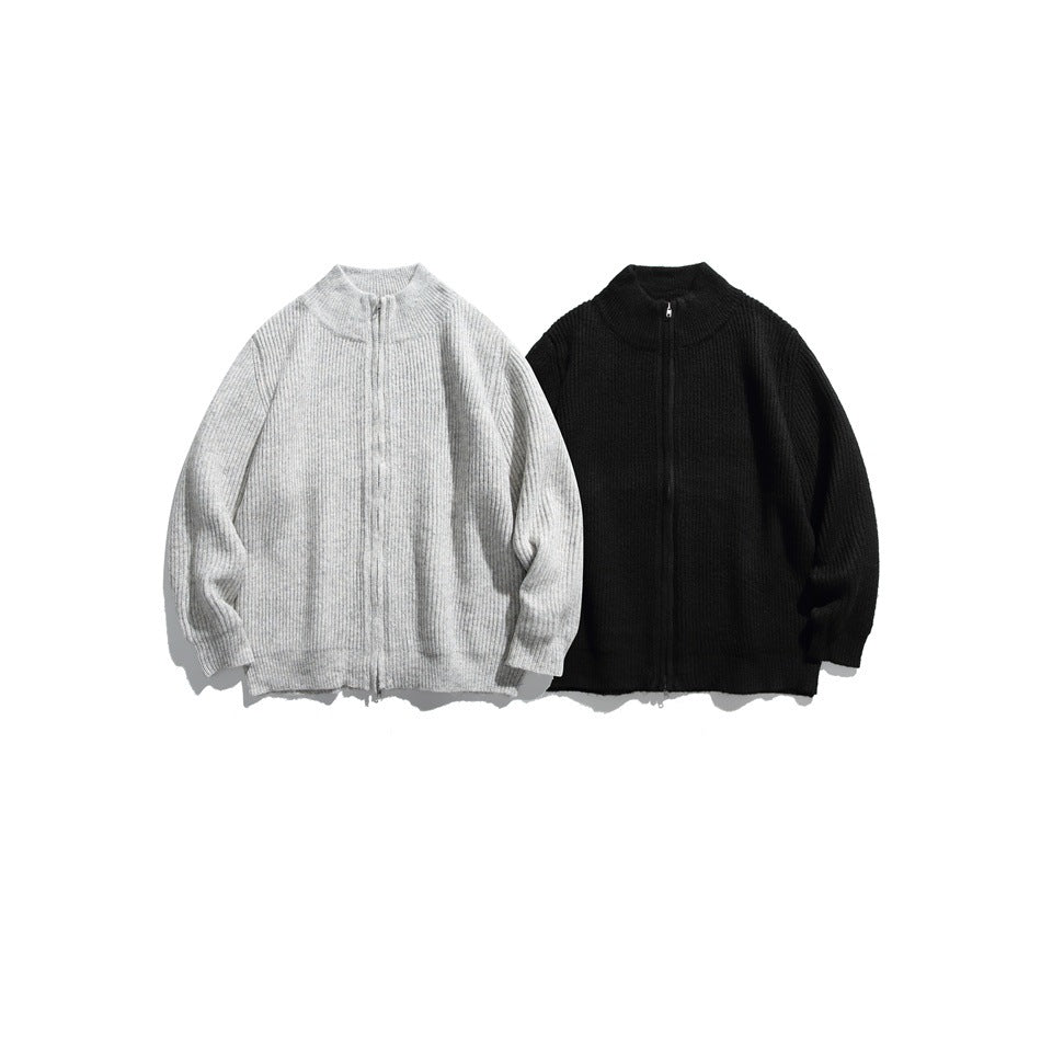 Front view of two rib-knit zip sweaters, one light gray and one black, with stand collars.