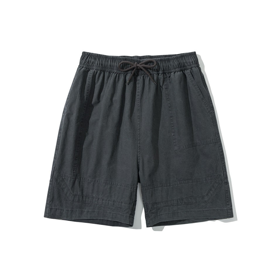 Gray knee-length shorts with elastic drawstring waist, front patch pocket and stitched panels at the hem, flat lay