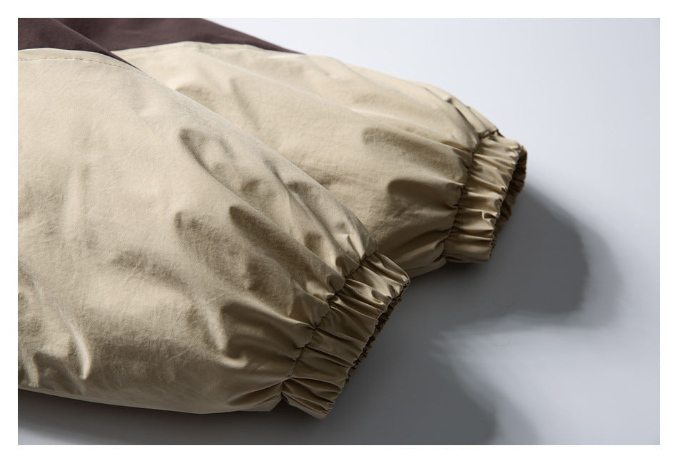 Close-up of a beige jacket sleeve ending in a gathered elastic cuff.