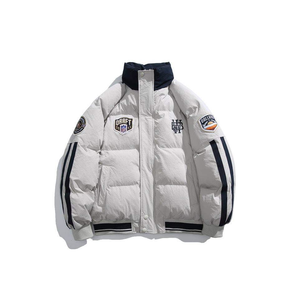 Light gray puffer jacket with navy stand collar, sleeve stripes, chest patches and striped ribbed hem, front view