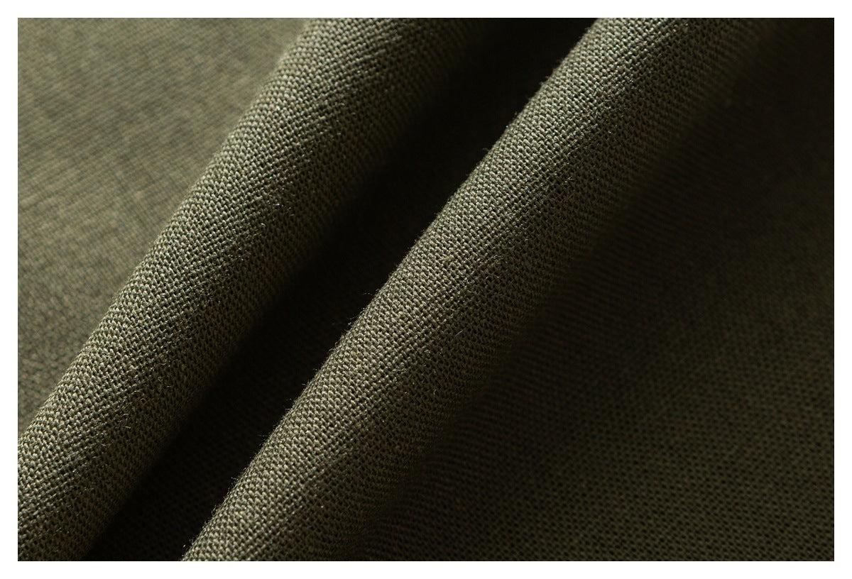 Macro view of olive green woven fabric draped in deep folds, highlighting its textured surface.