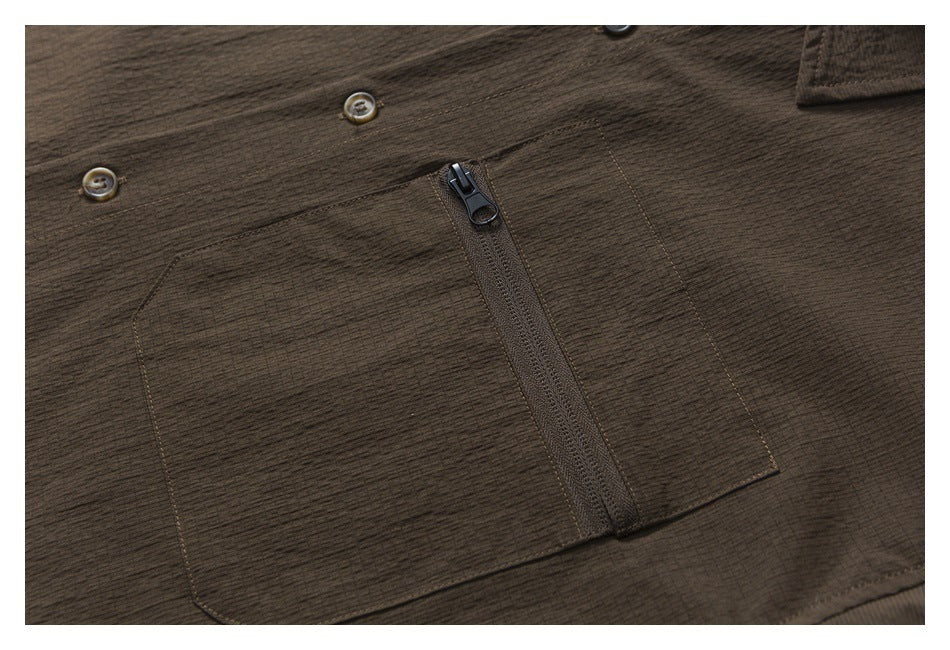 Close-up of a dark brown garment with a large zippered pocket and two buttons.
