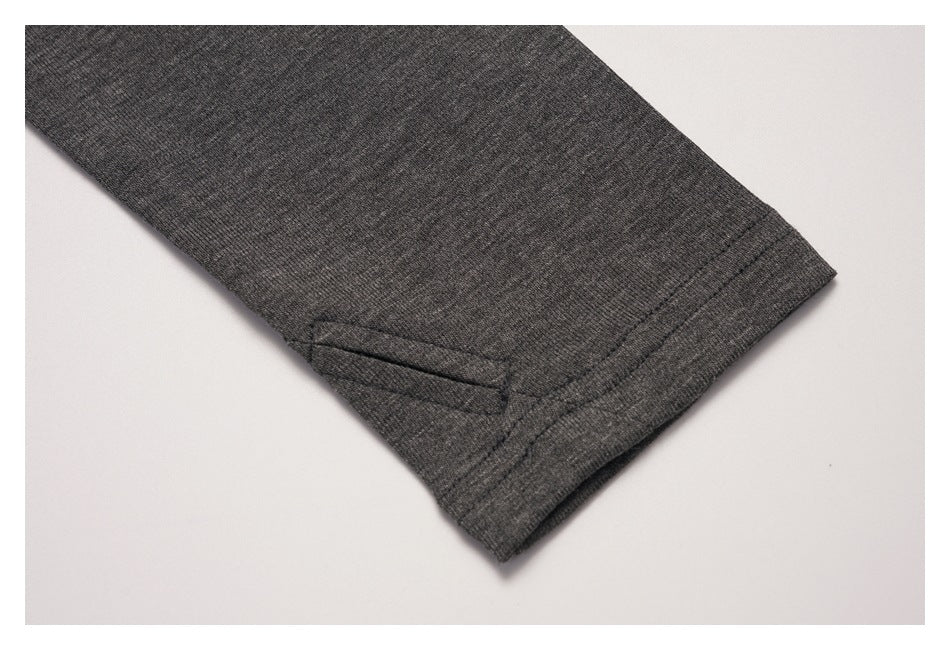 Close-up of a charcoal sleeve cuff with a small stitched detail.