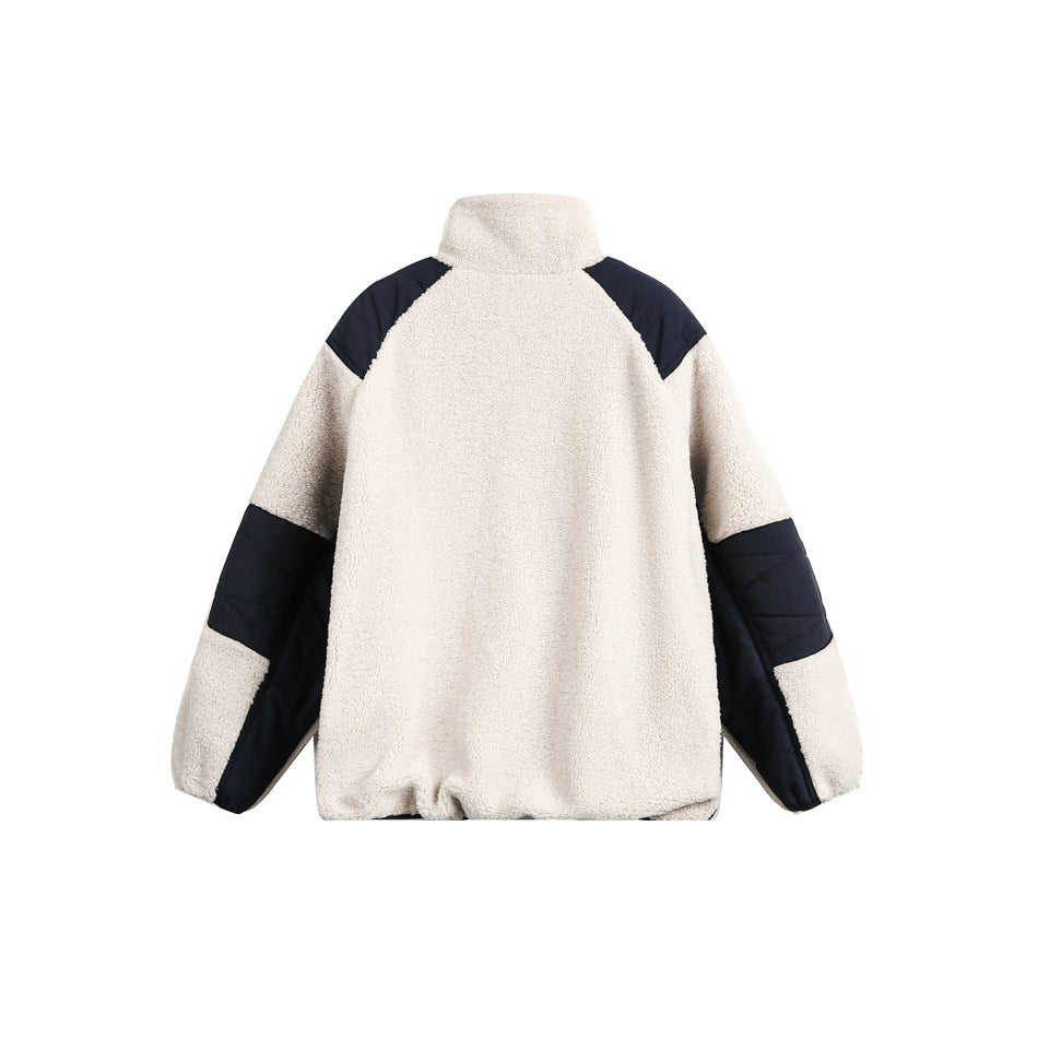Back view of a cream sherpa jacket with navy shoulder panels and navy sections along the sleeves.