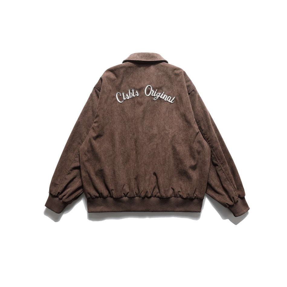 Back of brown corduroy-look jacket with large white script embroidery across the upper back and ribbed hem