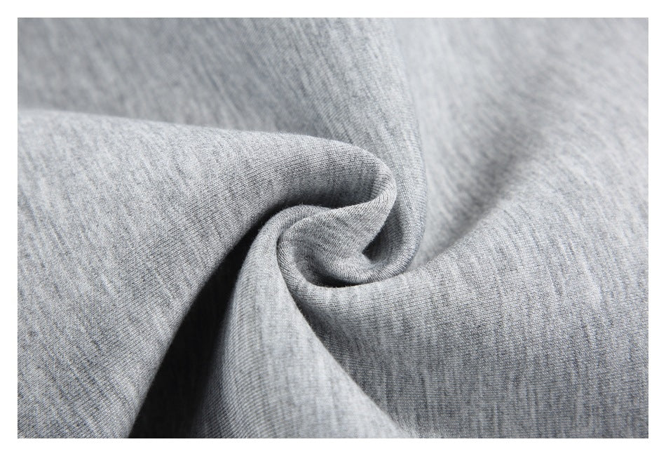 Close-up of heather gray knit fabric draped into soft folds.