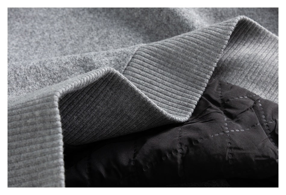 Close-up of a gray ribbed garment edge beside dark quilted lining.