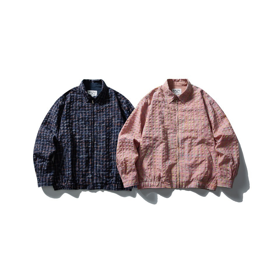 Two zip-front plaid jackets displayed side by side in navy and pink.