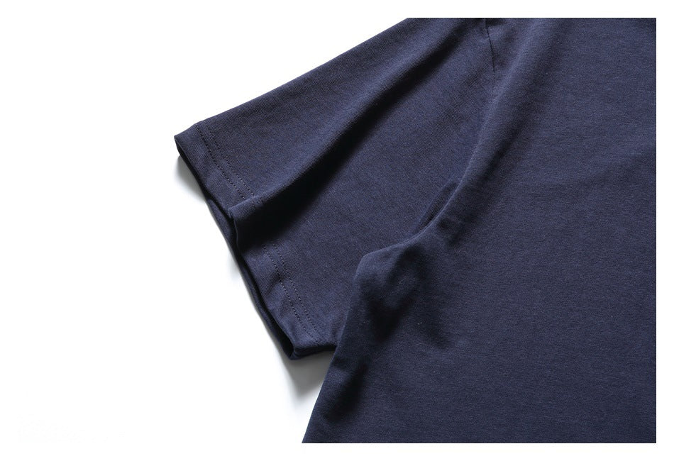Close-up of a navy short-sleeve shirt showing the sleeve and stitched hem.