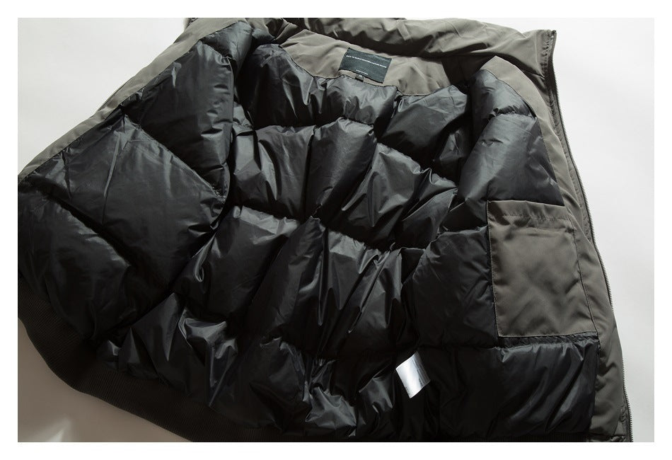 Open dark olive jacket showing its black quilted lining, interior pocket, and zipper.