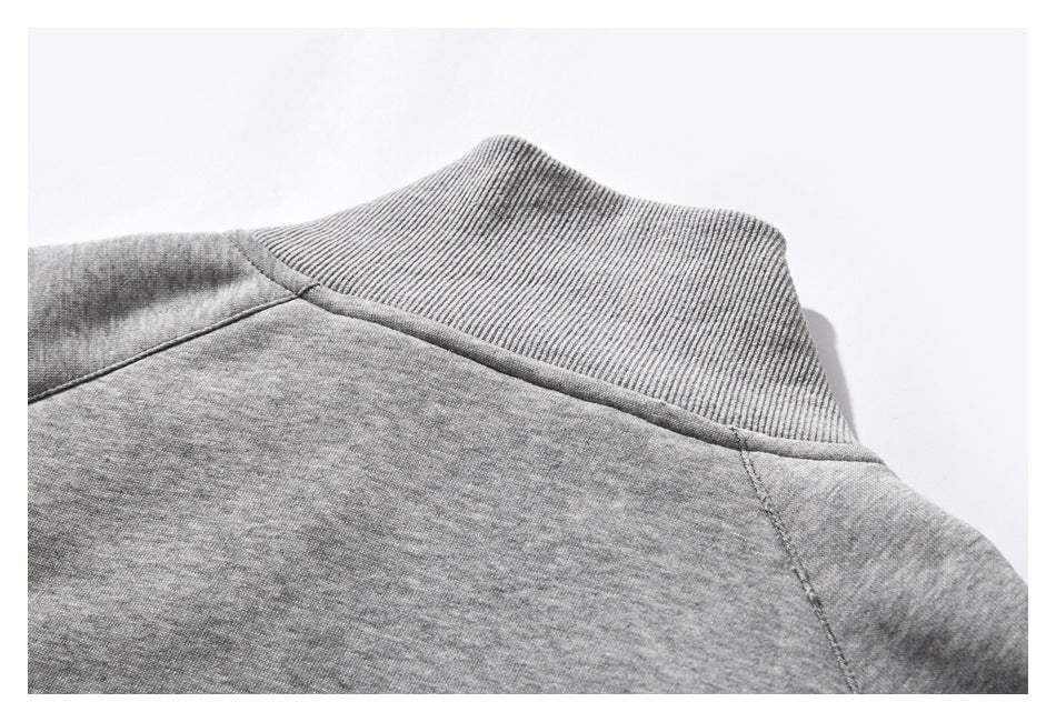 Close-up of the heather gray jacket's ribbed stand collar and back shoulder seams.