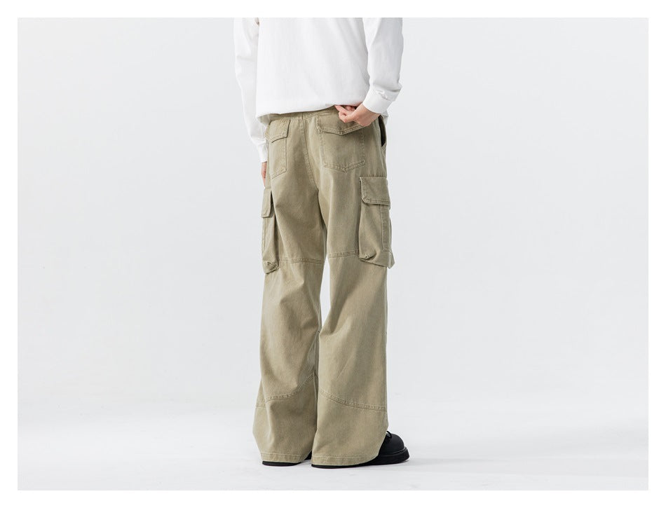 Model wearing loose olive-khaki cargo pants with rear pockets and side cargo pockets, back view.