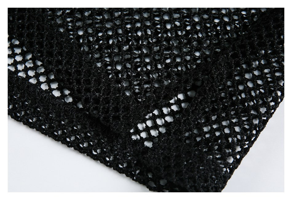 Close-up of black open-knit mesh with a thicker finished edge.