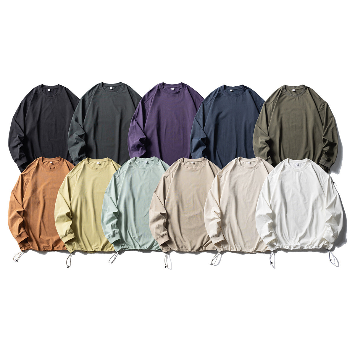 Twelve long-sleeve crewneck shirts arranged in two rows in assorted colors, with adjustable drawcord hems.