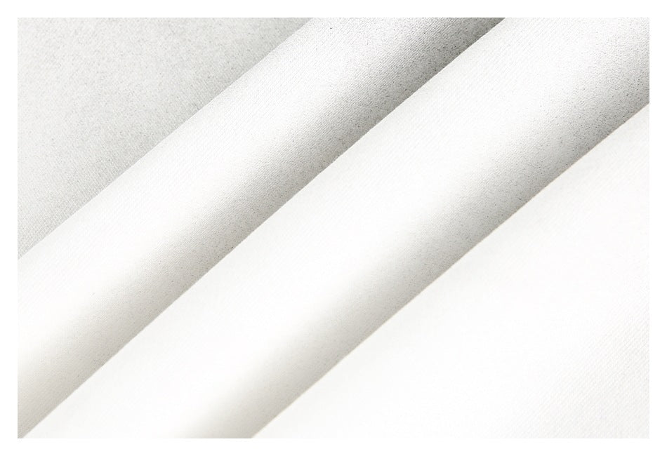 Macro view of layered off-white garment fabric showing its fine surface texture.