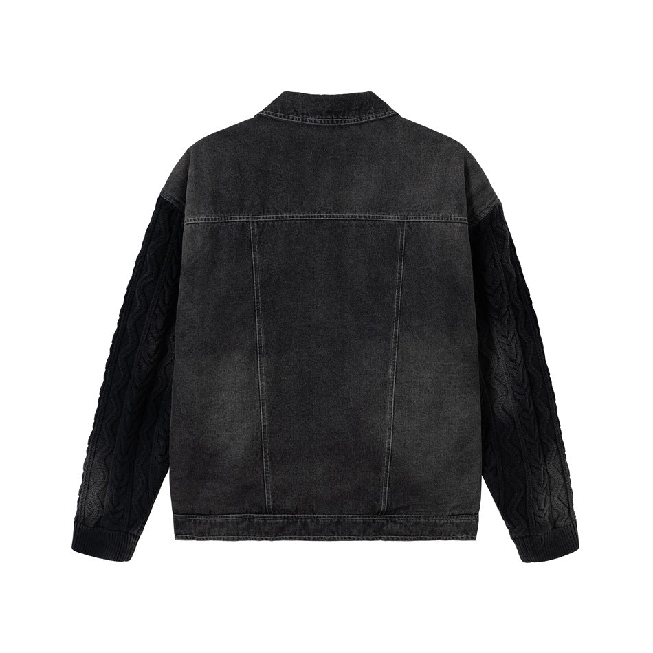 Back view of a charcoal denim jacket with black cable-knit sleeves and ribbed cuffs, shown against a white background.
