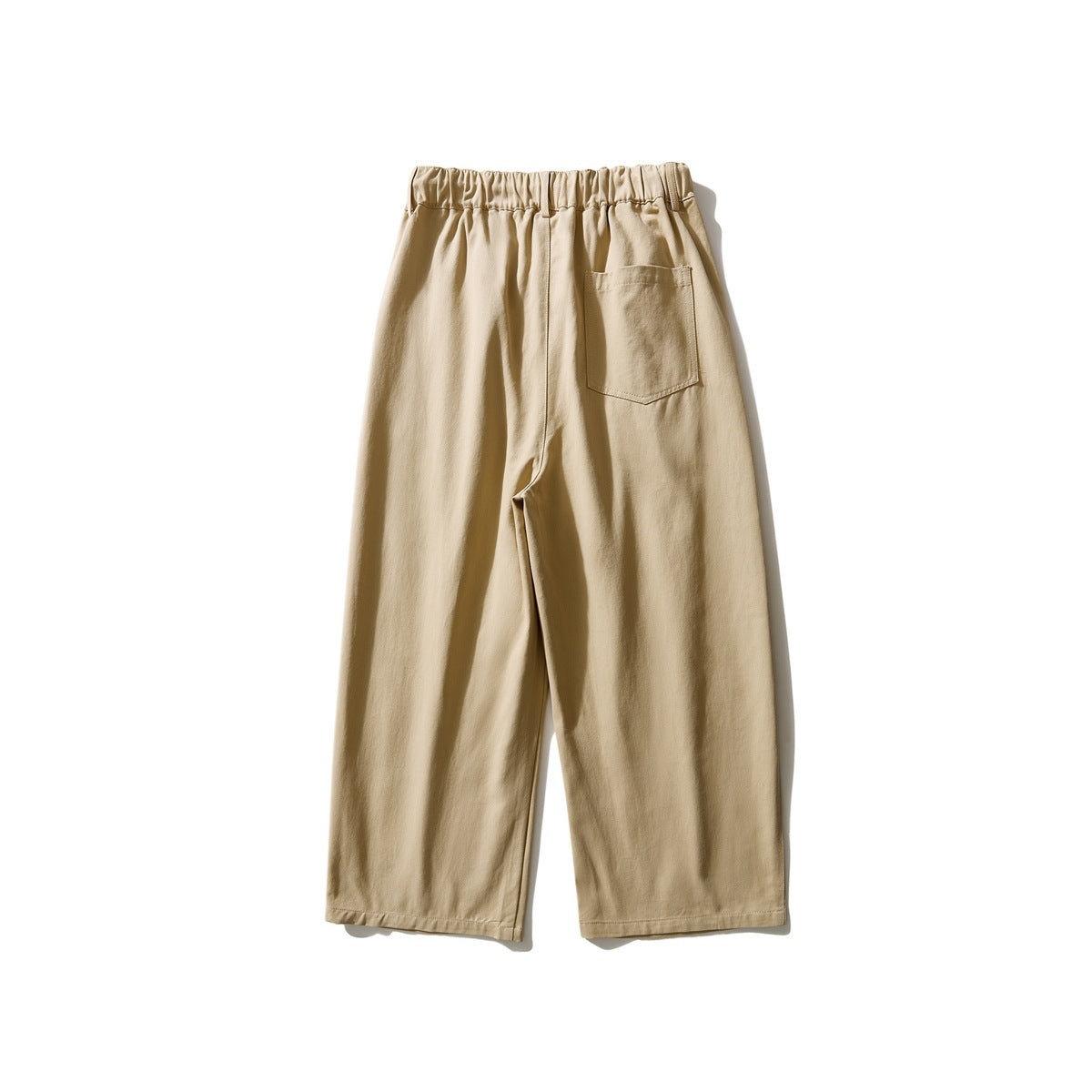 Back view of tan wide-leg pants with an elastic waistband and one patch pocket.