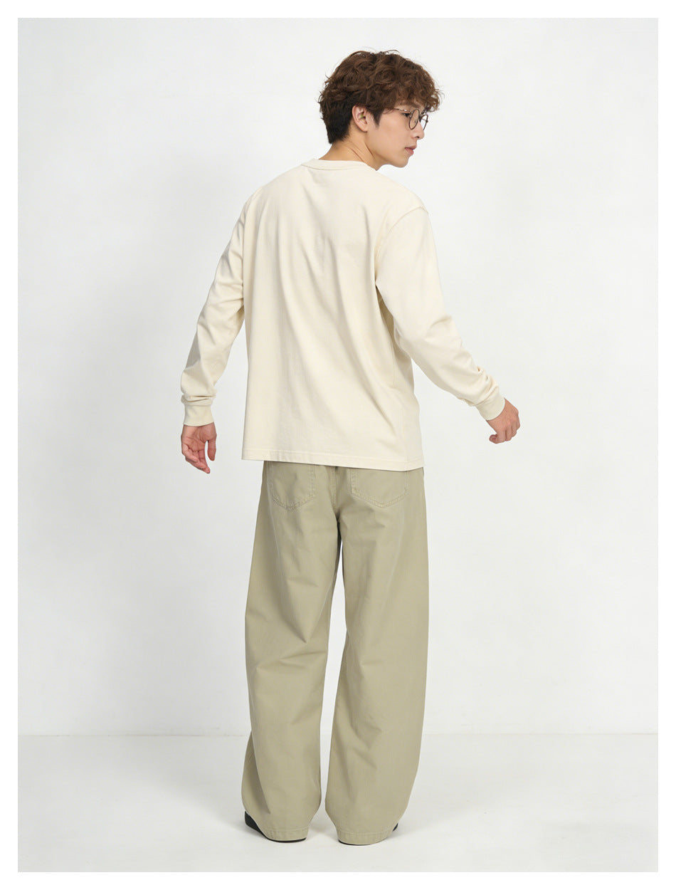 Model shown from behind wearing loose light khaki pants with back pockets and a cream long-sleeve shirt.