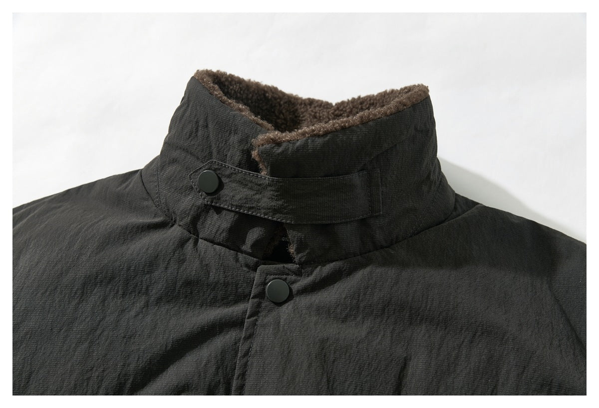 Close-up of the jacket’s raised charcoal collar with brown fleece lining and snap-button closure.