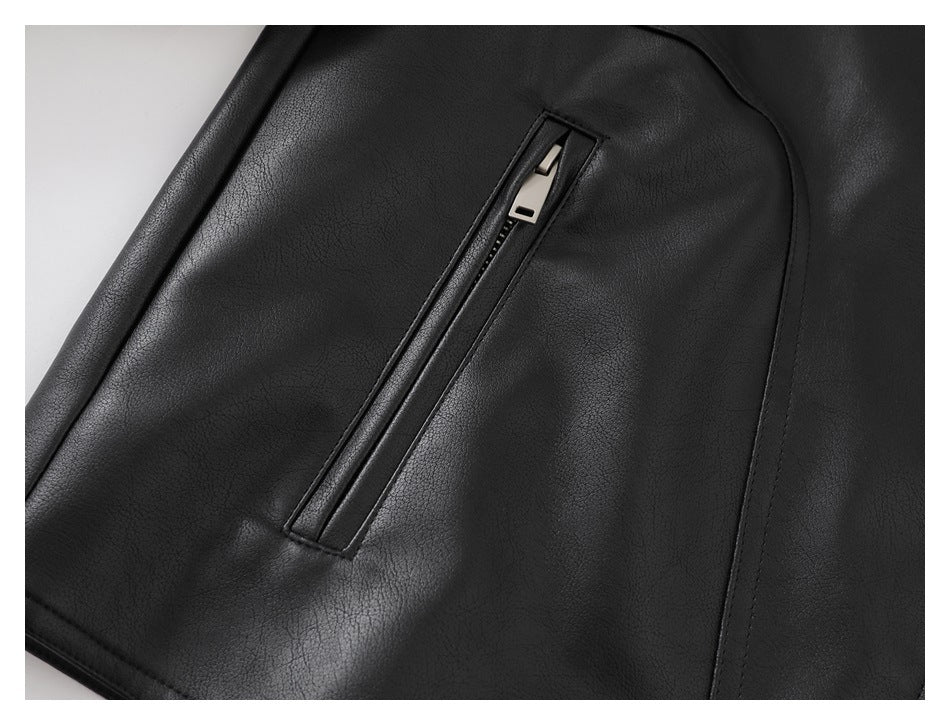 Close-up of a slanted zip pocket on a black jacket, with a silver zipper pull.