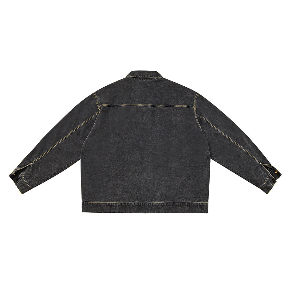 Back view of washed black denim jacket flat lay with yoke seam and golden topstitching