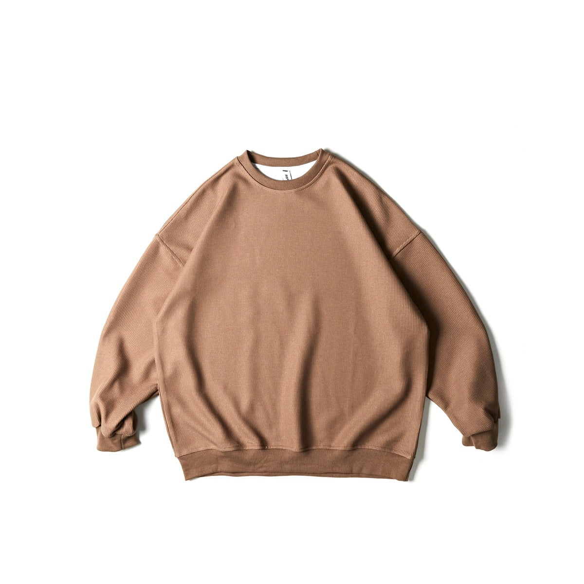 Light brown crew neck sweatshirt with visible fine rib texture and ribbed trim, flat lay front view