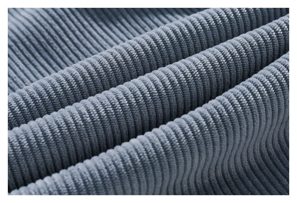 Close-up of gray corduroy fabric with prominent raised parallel ribs.