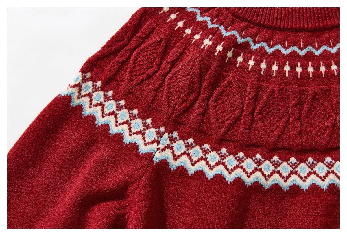 Close-up of the red sweater's textured cable-knit yoke and cream-and-blue geometric pattern.
