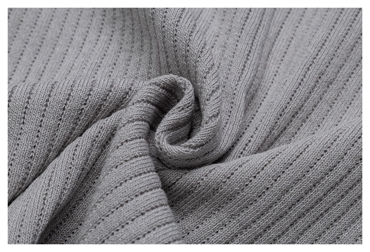Close-up of the light gray ribbed knit fabric gathered into soft folds.
