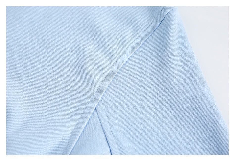 Close-up of a light blue garment seam with neat stitching.