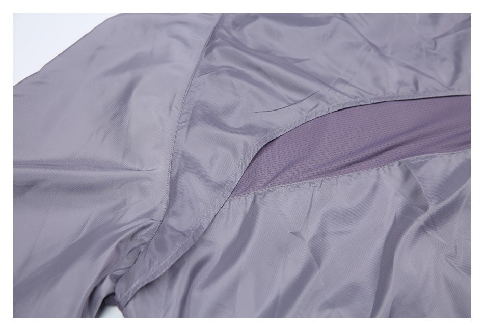 Close-up of the gray-purple jacket's curved mesh back vent and surrounding seams.