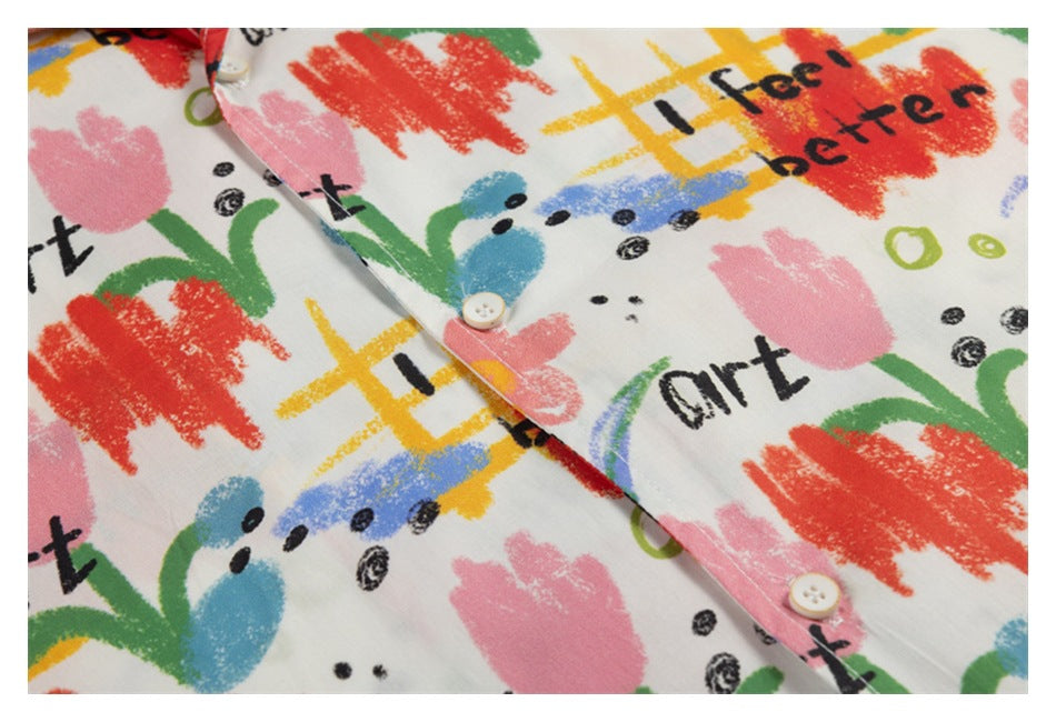 Close-up of the shirt's button placket and colorful abstract print with black English lettering.