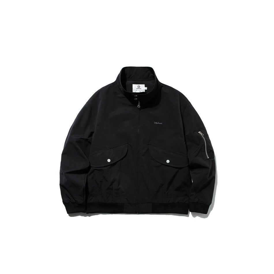 Black zip-front stand-collar jacket with two snap flap pockets, sleeve zip pocket and ribbed cuffs and hem, front view
