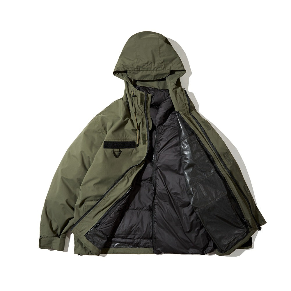 Olive hooded jacket opened to show its dark quilted inner layer and inner construction.