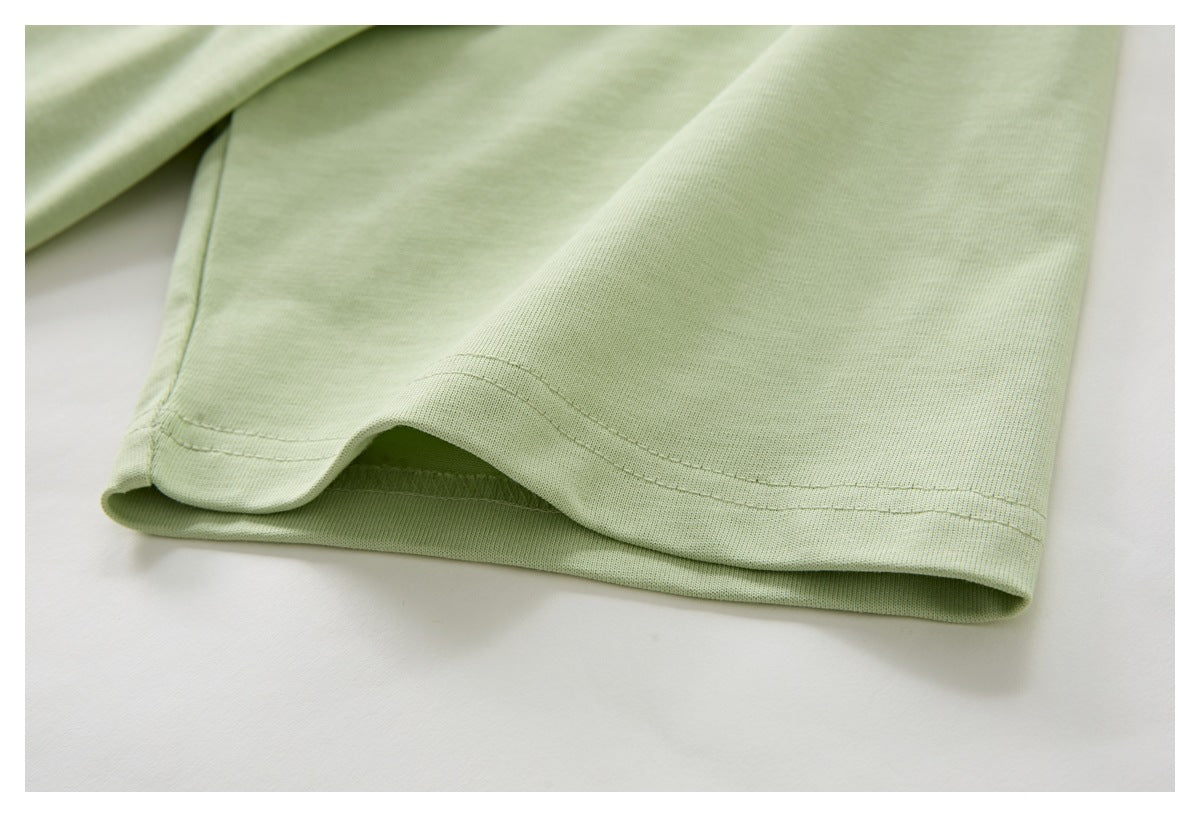 Close-up of the double-stitched hem on pale green fabric.