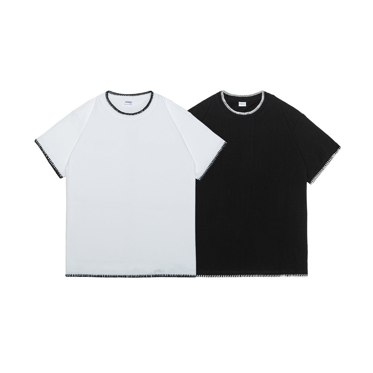White and black short-sleeve T-shirts shown from the front, each with contrasting blanket stitching at the neckline, sleeves