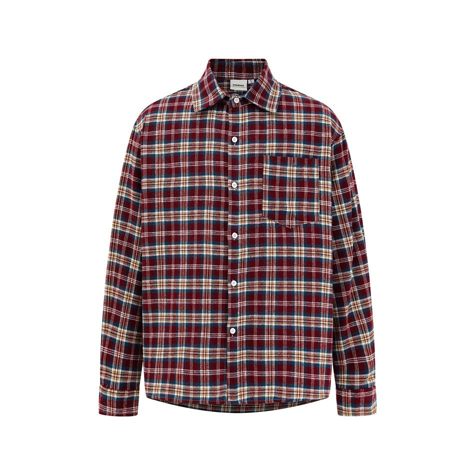 Front view of a red plaid long-sleeve button-up shirt with collar, chest pocket and buttoned cuffs on a white background