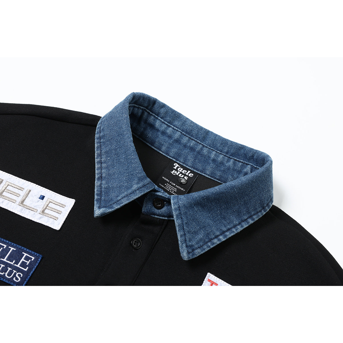 Close-up of a black pullover's blue denim collar, button placket and sewn logo patches.