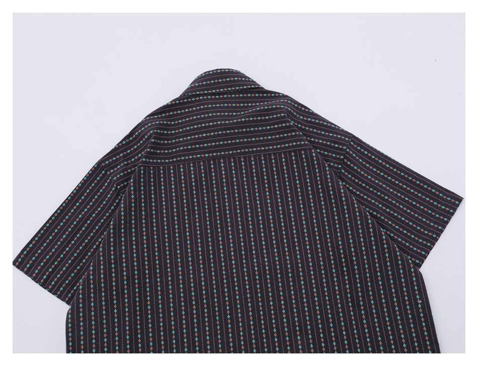 Flat-lay back view of a dark short-sleeve shirt with repeating turquoise and rust motifs.