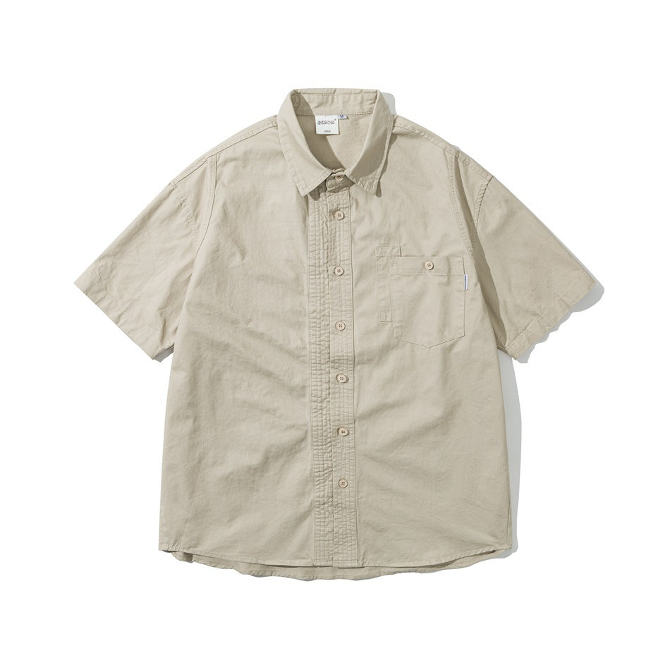 Light khaki short-sleeve button-up shirt with a pointed collar, pleated-look placket and a buttoned chest pocket