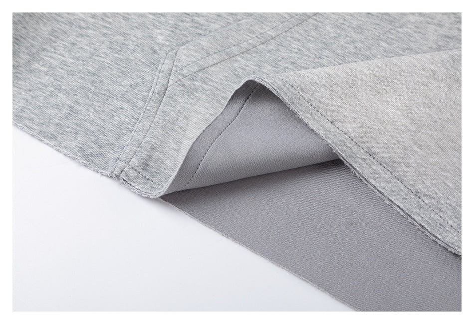 Close-up showing the inside seam and folded edge of heather-gray fabric.