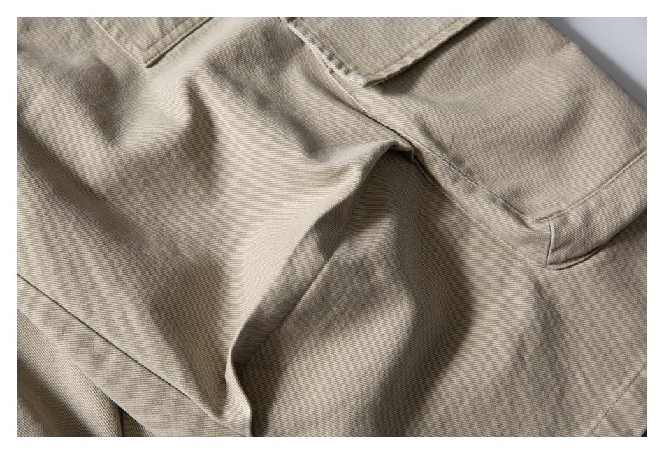 Close-up of beige shorts fabric and stitched panel seams.