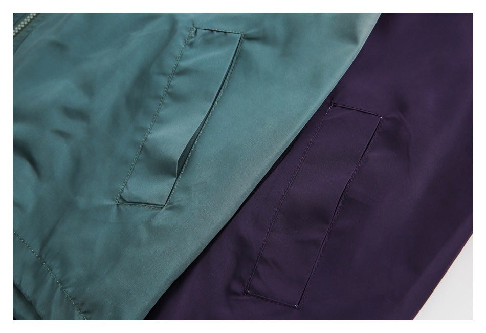 Close-up of teal and deep purple jackets showing their narrow stitched pocket openings.