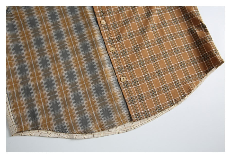 Cropped flat lay of a two-tone plaid button-up shirt, showing the front placket, buttons, and curved hem.