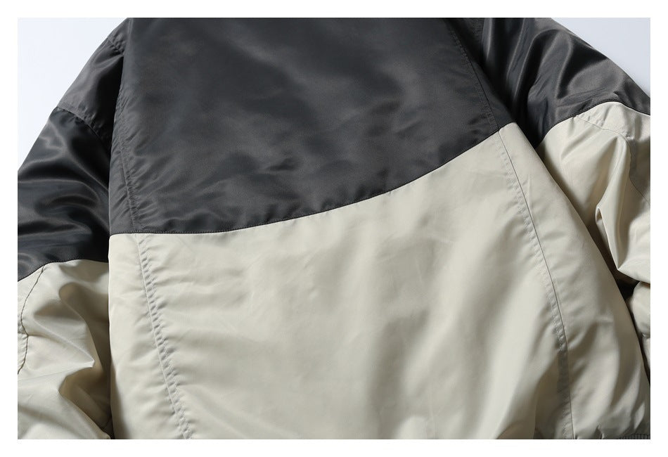 Close-up of a color-block jacket back with a dark upper panel and light beige lower panel.