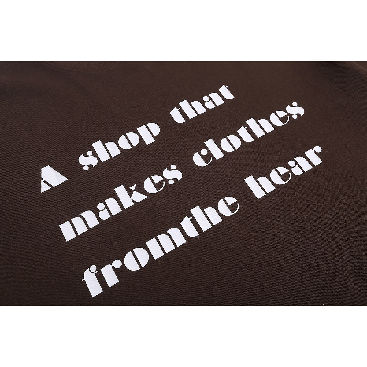 Close-up of a dark brown T-shirt with large white, multi-line text printed across the front.