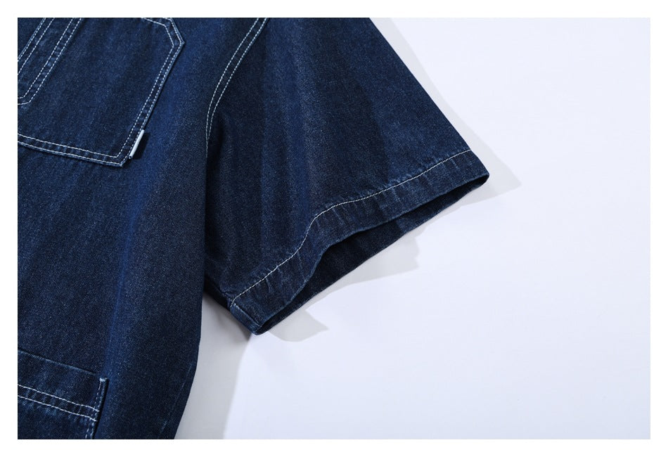 Close-up of a short sleeve and stitched edge on a dark indigo denim garment.