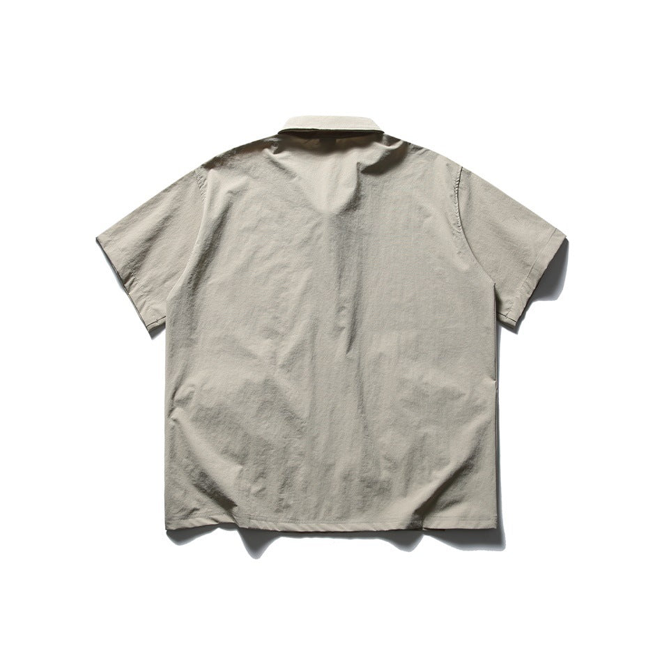 Back view of a light beige short-sleeve shirt with a collar.