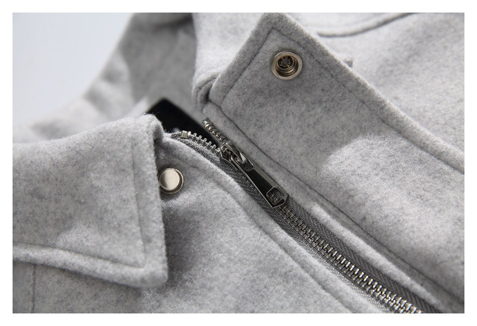 Close-up of the coat's metal zipper, snap fasteners, and light gray collar.